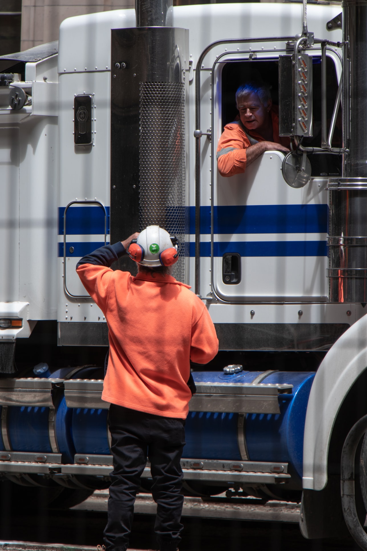 Two truck drivers talking.